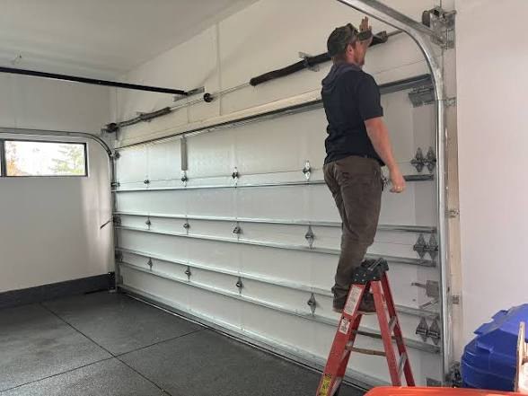 Technician servicing a garage door
